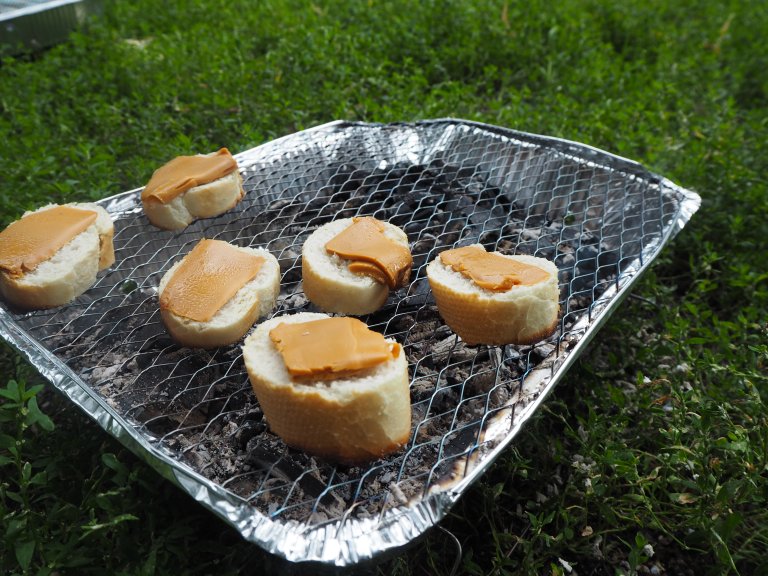 A slice of bread with brunost on the grill